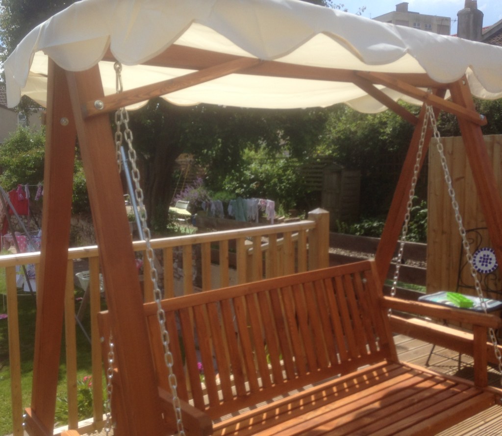 A flat packed assembled swinging garden chair 